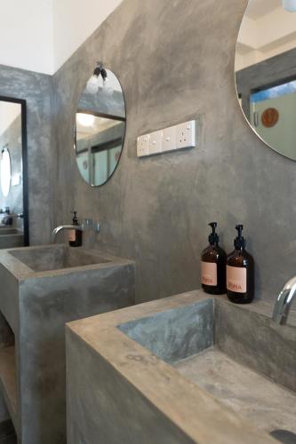a bathroom with two sinks and a mirror at Mira Mirissa in Mirissa
