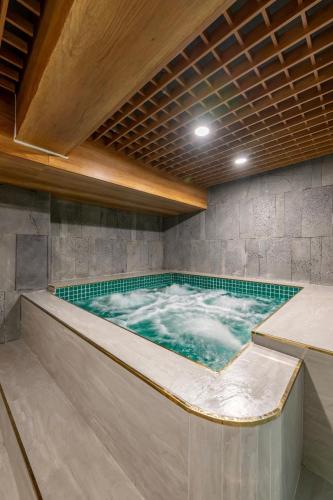 a large jacuzzi tub in a room with at Elegance Ninh Binh Hotel in Kỳ Vĩ