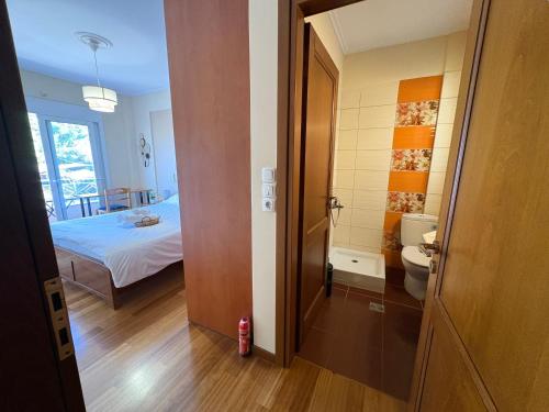 a room with a bed and a bathroom with a toilet at Purerest Entire Private Villa in Athens