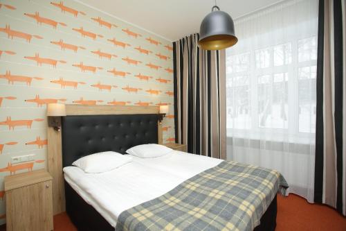 Postel nebo postele na pokoji v ubytování Pühajärve Spa & Holiday Resort