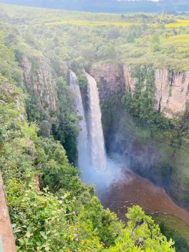 an aerial view of a waterfall in a canyon at Zindi Zindiza Lodge in Sandrivier