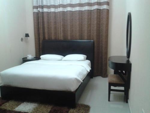 Postel nebo postele na pokoji v ubytování Al Smou Hotel Apartments - MAHA HOSPITALITY GROUP