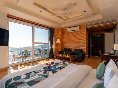 a bedroom with a bed and a living room at Moustache Select Mcleodganj in Dharamshala