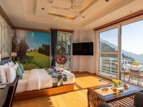 a bedroom with a large bed and a large window at Moustache Select Mcleodganj in Dharamshala