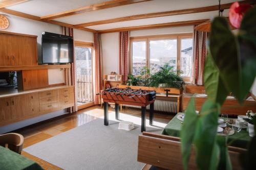 a living room with a foosball table in the middle at Alpenblick Gösweiner in Windischgarsten
