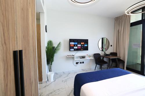 a hotel room with a bed and a desk at Chic Studio near Cleveland by Central Stay in Abu Dhabi