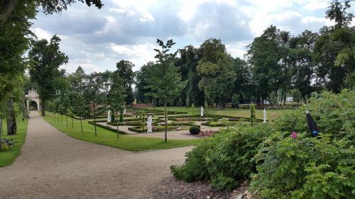 a park with trees and bushes and a pathway at Da Vinci in Chęciny