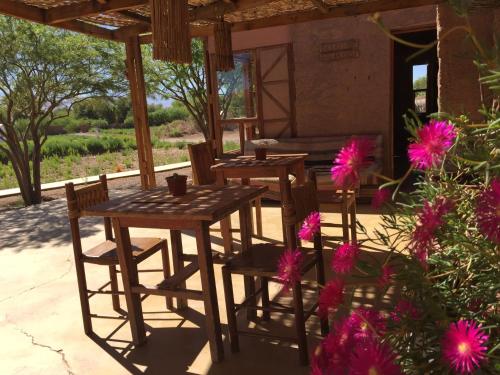a table with chairs and a table cloth at Lodge Altitud in San Pedro de Atacama