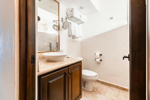 a bathroom with a sink and a toilet at Punta Pescadero Paradise Hotel & Villas in Los Barriles
