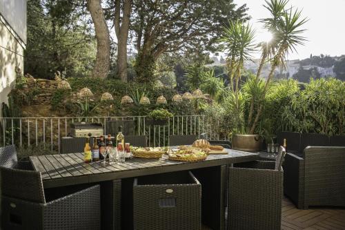 a table with food and drinks on a patio at Résidence la Grande Voile in Banyuls-sur-Mer