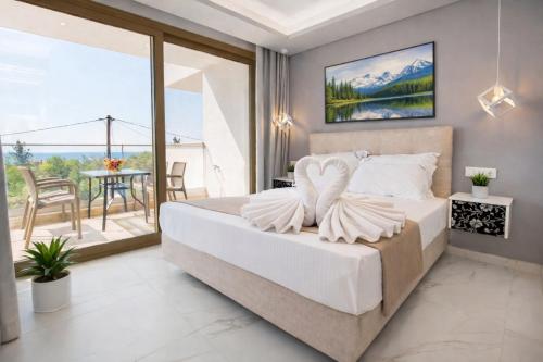 a bedroom with a bed and a balcony at MPL Apartments & maisonettes in Limenaria