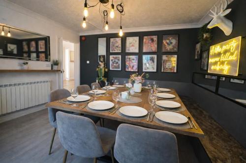 a dining room with a wooden table and chairs at Bh2Beach House,4mins to the beach, centrally located, group stays in Bournemouth
