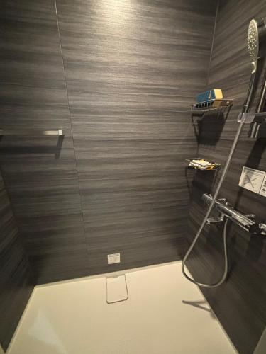 a bathroom with a shower with a glass door at P-STAY広島平和公園withペット 301号室 in Hiroshima