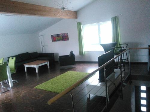 a living room with a couch and a table at Ferienwohnung zum Kletterturm in Kaufbeuren