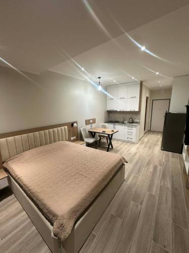 a bedroom with a bed and a table in it at Solis Residence Batumi in Batumi