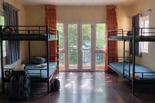 a room with three bunk beds and a window at 88 Ehome Noibai Airport in Hanoi