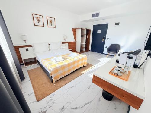 a hotel room with a bed and a desk with a computer at RUBO Hotel in Shumen
