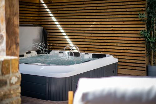 a bath tub with a water fountain in it at The Old Vicarage Irton in Parton