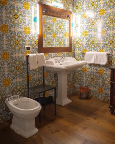 a bathroom with a sink and a toilet at Locanda Al Cappello in Udine