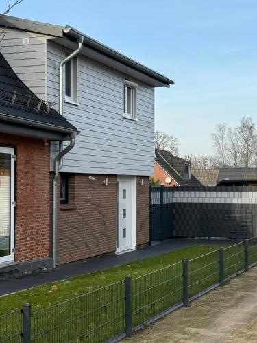 a house with a fence in front of it at Ferienwohnung Theus in Albersdorf