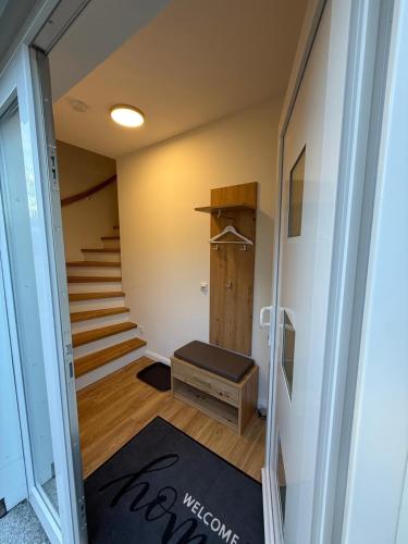 a room with stairs and a hallway with a rug at Ferienwohnung Theus in Albersdorf