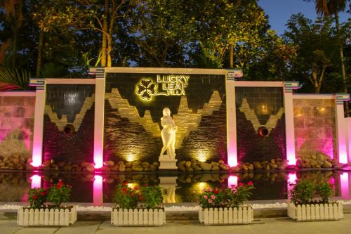 a sign for a luxury hotel at night at Lucky Leaf Hoian Villa in Hoi An