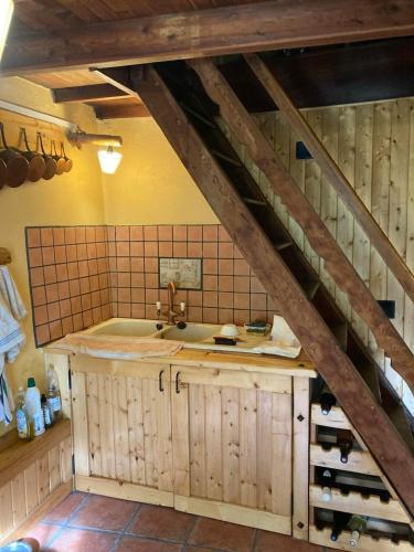 a kitchen with a sink and a wooden staircase at Refuge-style chalet Mountain view in Colmars