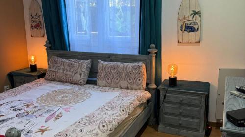 a bedroom with a bed with two night stands and a window at CHESA RUISA in Castro Marim