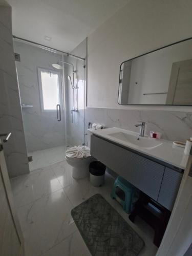 a bathroom with a sink and a shower and a mirror at The nice condo 2 BR at Karon in Karon Beach