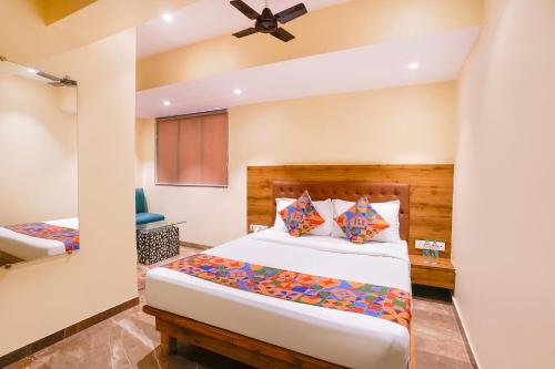 a bedroom with a bed in a room at FabHotel Samrath in Mumbai