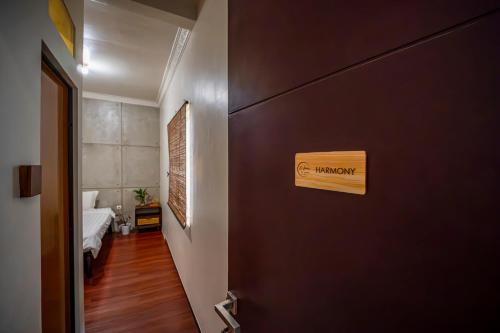a hallway with a door with a sign on it at Dhome by Riana in Wendit