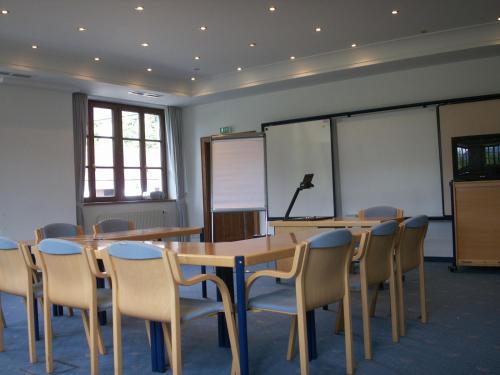 a conference room with a table and chairs and a podium at Landgasthof Mayr in Steyr