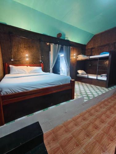 a bedroom with a large bed with a wooden headboard at The love shack atChaba in Ko Lanta