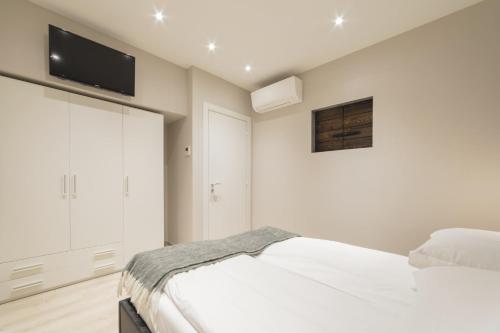 a bedroom with a bed and a tv on the wall at Suite del Pirata in Gargnano