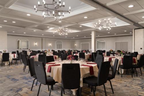 a banquet room with tables and chairs and chandeliers at DoubleTree by Hilton Providence Airport Warwick in Warwick