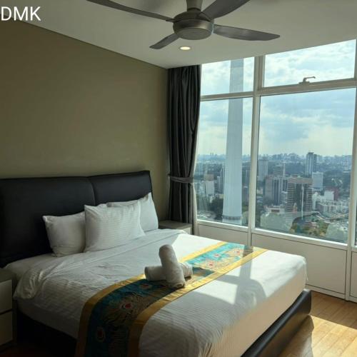 a bedroom with a bed with a large window at vortex luxury APATMENT BY FRINDSHIP in Kuala Lumpur