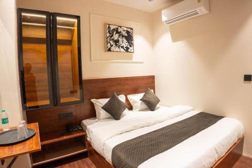 a bedroom with a large bed in a room at Comfy GK Residency in New Delhi