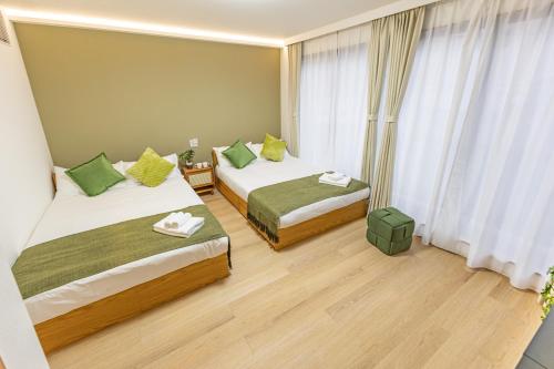 a hotel room with two beds and a window at KOKORO INN TOKYO 5-minute walk to Senso-ji Temple Four-story private house with two bathrooms luxury stay in Tokyo