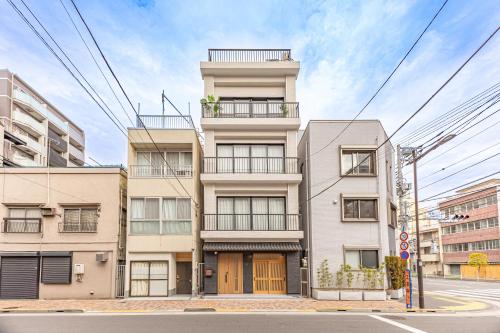 an apartment building with balconies on a street at KOKORO INN TOKYO 5-minute walk to Senso-ji Temple Four-story private house with two bathrooms luxury stay in Tokyo
