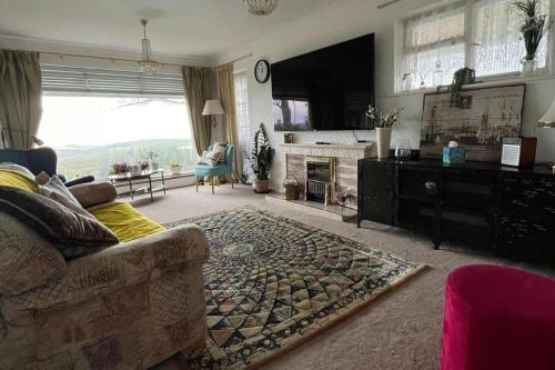 a living room with a couch and a fireplace at House - Free Parking & Sea Views in Brighton & Hove