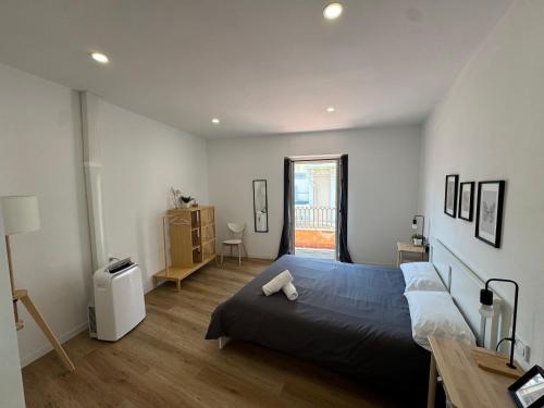 a bedroom with a blue bed in a room at Larios Rooms in Málaga
