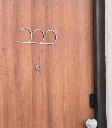 a wooden door with the number on it at SeaBreeze - Torre San Giovanni in Torre San Giovanni Ugento