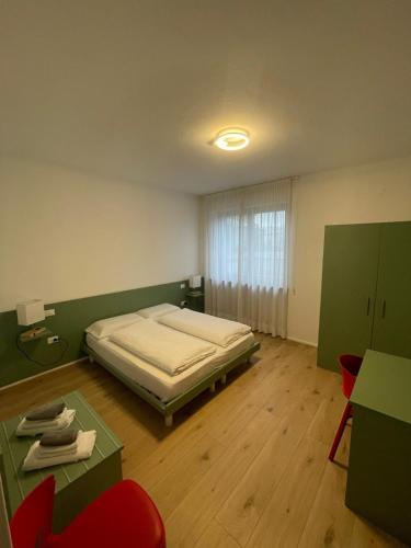 a bedroom with a bed and a table and chairs at Countryhouse Verso in Rovereto