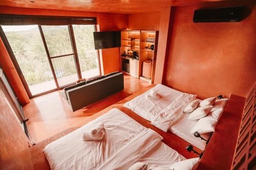 a bedroom with two beds in a room with windows at C South Hideout in Butong