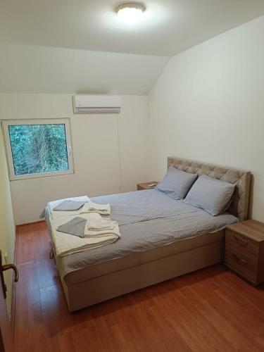 a bedroom with a bed in a room with a window at Una Apartments in Budva