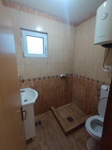 a bathroom with a toilet and a sink at Una Apartments in Budva