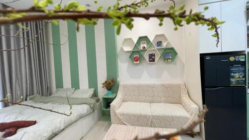 a small bedroom with a bed and a chair at Vinsmart City Cam Cam homestay in Phú Thú