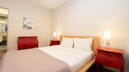 a bedroom with a bed and two red cabinets at Gardenia Apartment by LovelyStay in Funchal