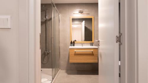a bathroom with a sink and a mirror at Gardenia Apartment by LovelyStay in Funchal