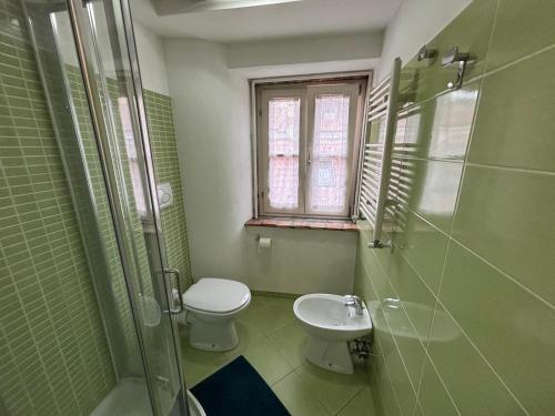 a bathroom with a toilet and a shower and a sink at Torretta International in Trieste